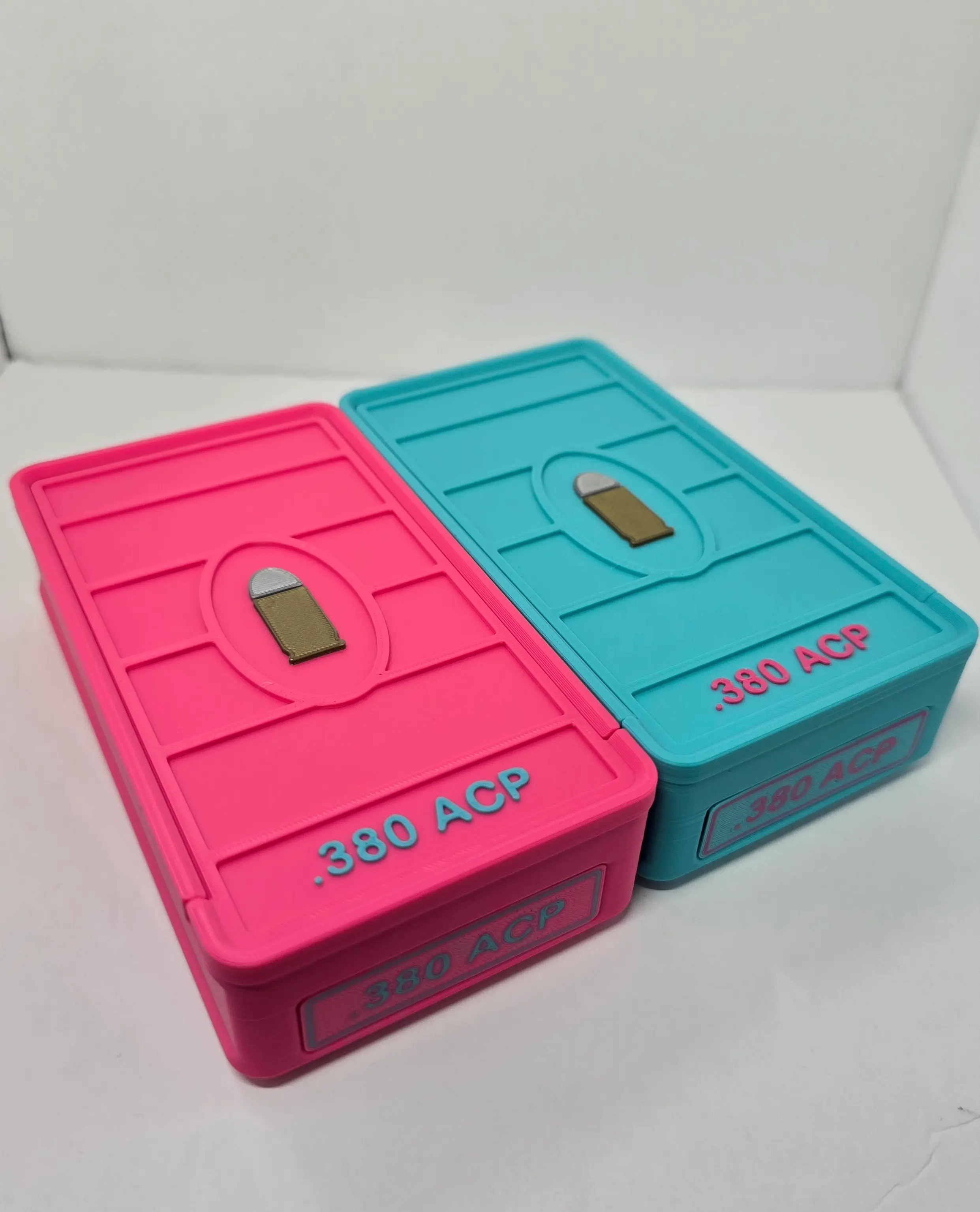 Front angled view of custom Hot Pink and Turquoise .380 ACP ForgeBox ammo boxes