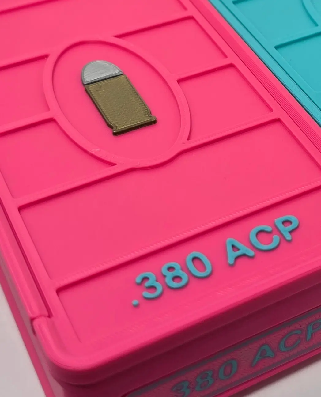 Close-up of Turquoise .380 ACP lettering on a Hot Pink ForgeBox ammo box