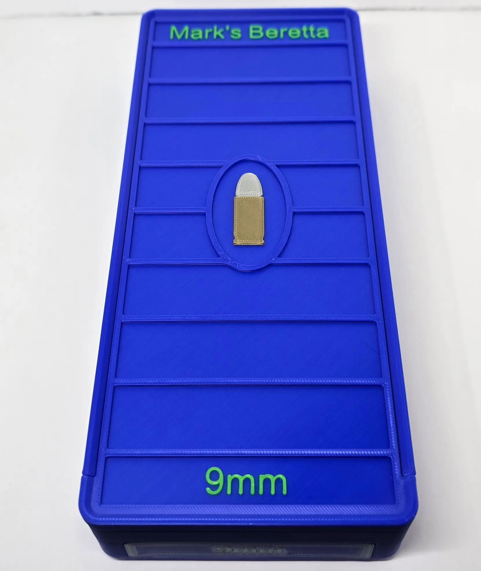 Lid detail of Blue 9mm ForgeBox with Green text
